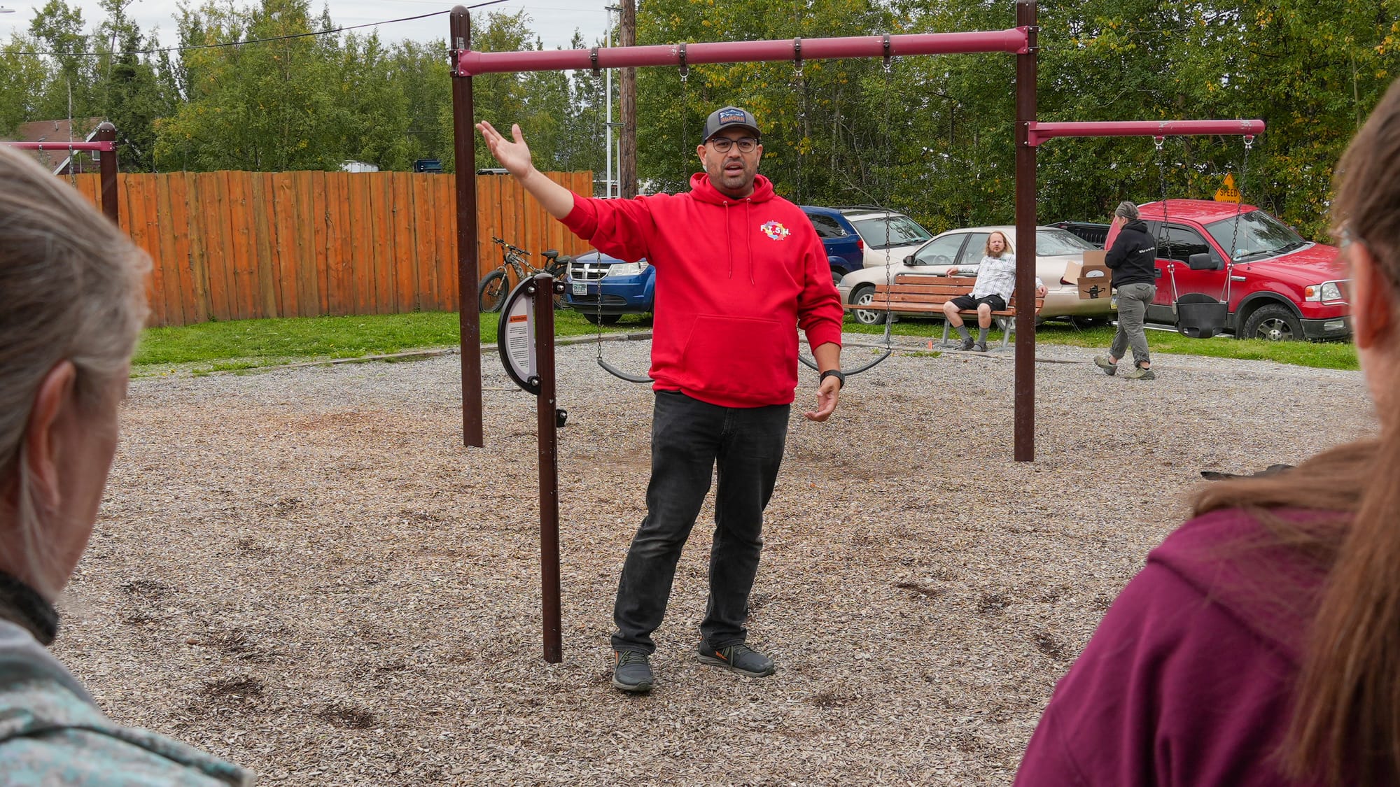 Assistant Borough Planning Director Jason Ortiz speaks to residents at a community picnic in Willawa