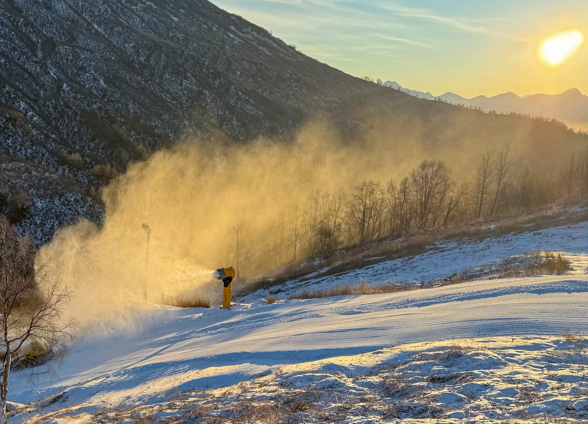 Artificial snow from a snowmaking gun flies into the air on Saturday, Dec. 20, 2025 at Skeetawk&nbsp;ski area in Hatcher Pass