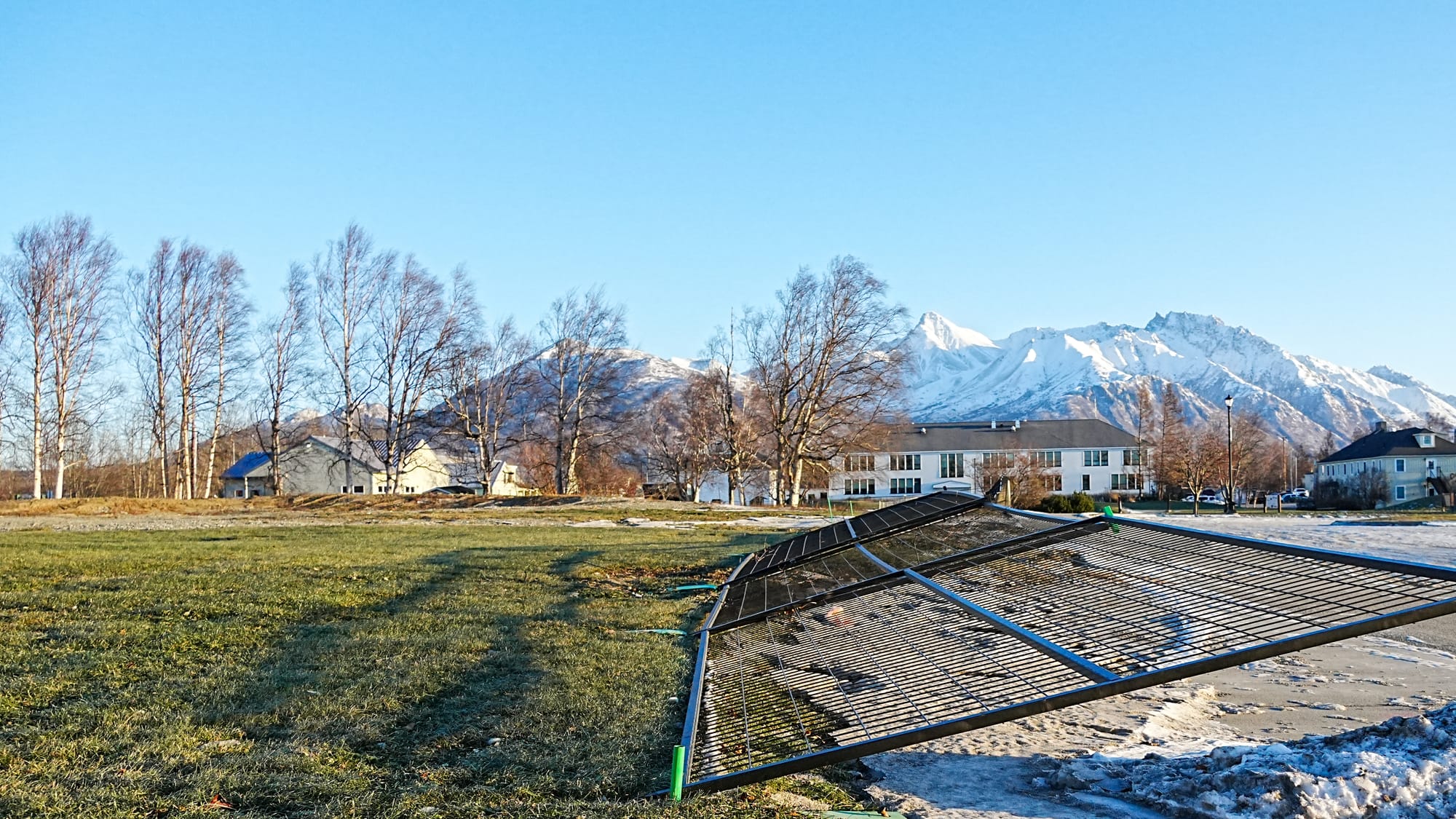 Fencing sits on the ground at the site of the Palmer Public Library
