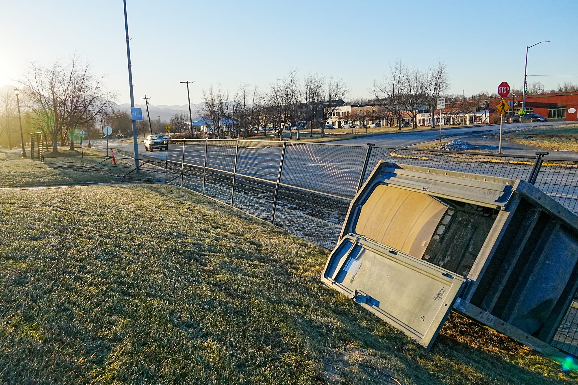 A wayward porta-potty sits against fencing destroyed during the windstorm