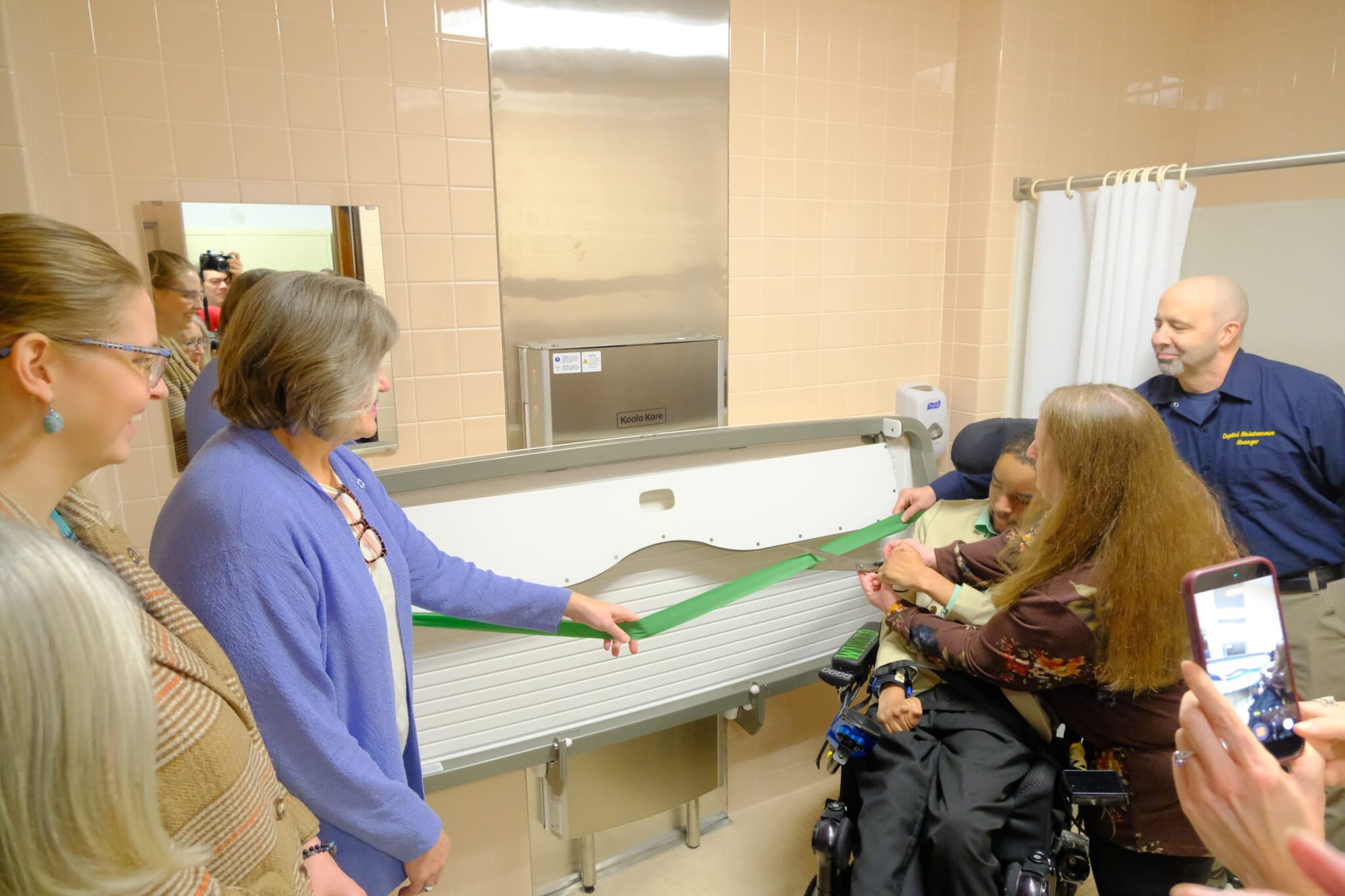 Judy and Eric Edwards gather with Reps. Sara Hannan, D-Juneau and Ashley Carrick, D-Fairbanks, and Capitol facilities manager Serge Lesh
