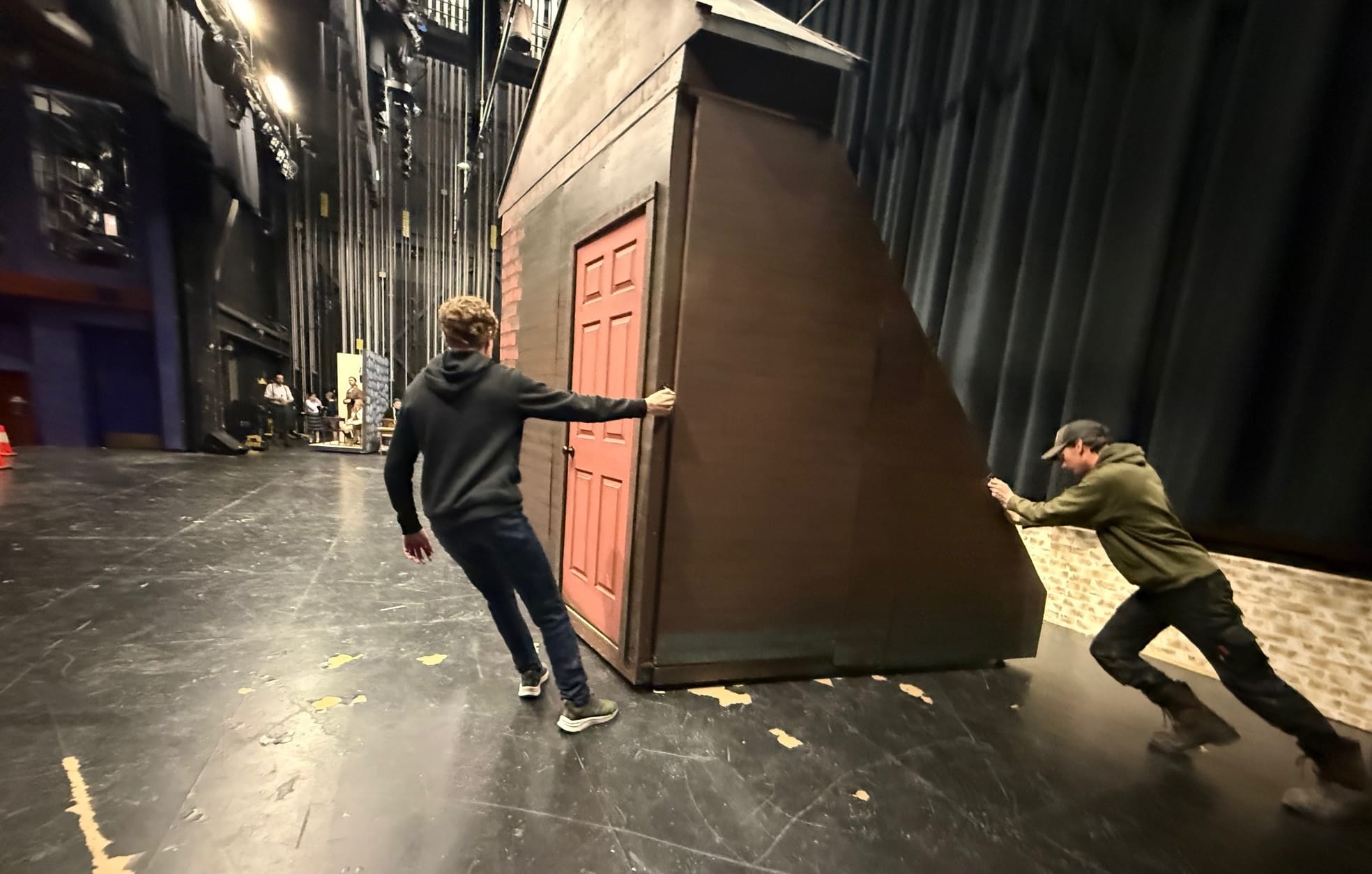 A pair of stagehands move equipment during a rehearsal for Valley Performing Arts