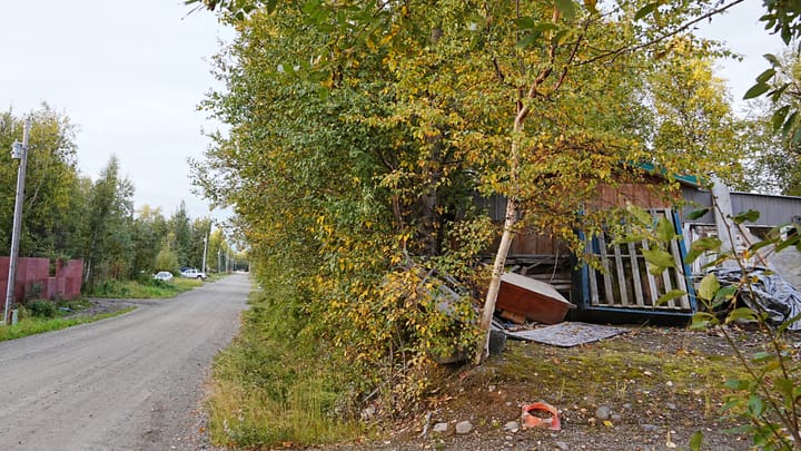 Piles of junk sit on a property on North Williwaw Way