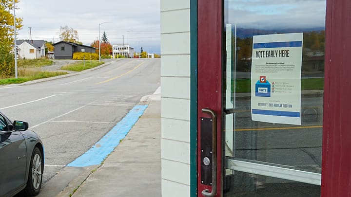 An early voting sign hangs on Wasilla City Hall