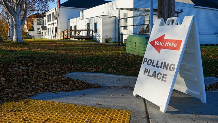A "vote here" polling place sign sits outside the Borough Administration Building in Palmer, Alaska