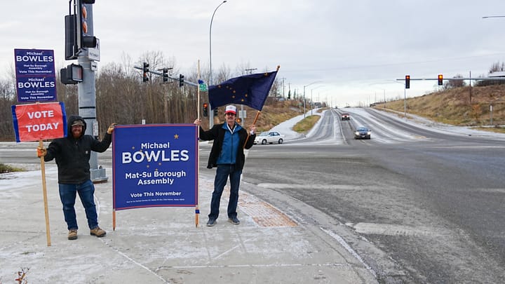 Volunteers wave signs for Mat-Su Borough Assembly candidate Michael Bowles