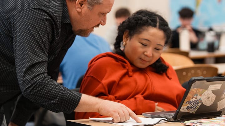 A Houston Middle School student speaks to a teacher