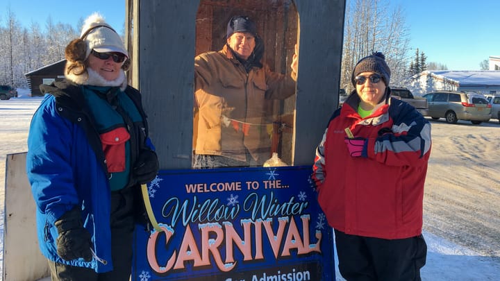 Volunteers welcome visitors to the Willow Winter Carnival
