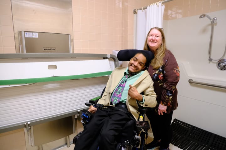 Judy and Eric Edwards pose for a photo at a ribbon cutting ceremony