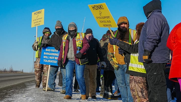 Members of Teamsters Local 959 strike outside the Durham School Services bus barn