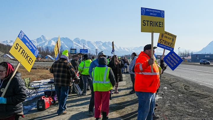 Mat-Su school bus workers hold signs on the strike line